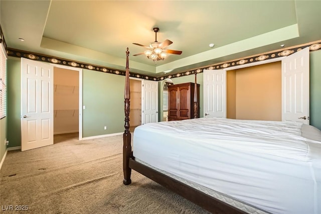 3910 Internet Ave, North Las Vegas, NV 89031 - bedroom featuring a tray ceiling, carpet, baseboards, and a spacious closet