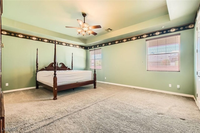 3910 Internet Ave, North Las Vegas, NV 89031 - carpeted bedroom with a tray ceiling, baseboards, and ceiling fan