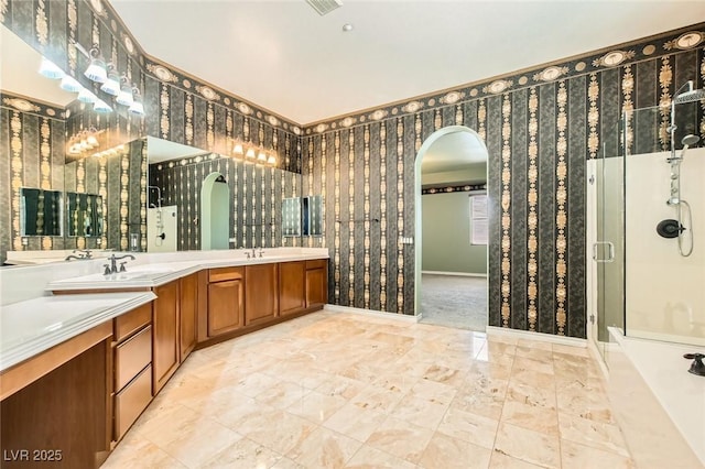 3910 Internet Ave, North Las Vegas, NV 89031 - full bath with double vanity, a shower stall, marble look tiles, and baseboards
