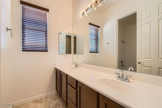 3910 Internet Ave, North Las Vegas, NV 89031 - full bathroom featuring baseboards and double vanity