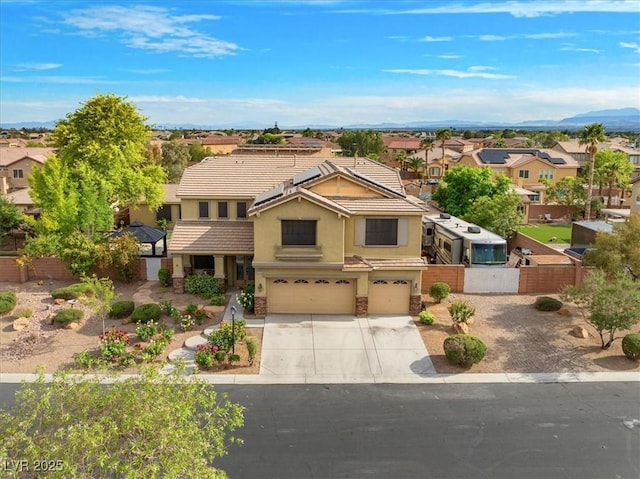 6335 Iginlas Goal Ave, Las Vegas, NV 89131 - view of front facade featuring fence, stucco siding, concrete driveway, an attached garage, and a residential view
