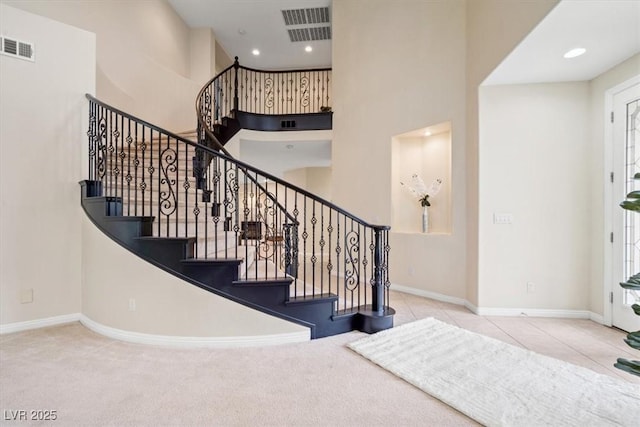 6335 Iginlas Goal Ave, Las Vegas, NV 89131 - stairway with carpet flooring, a high ceiling, visible vents, and baseboards