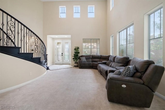 6335 Iginlas Goal Ave, Las Vegas, NV 89131 - living area featuring stairs, baseboards, a high ceiling, french doors, and carpet