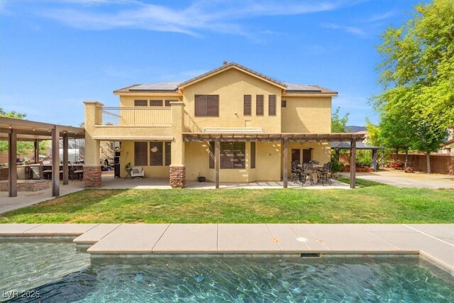 6335 Iginlas Goal Ave, Las Vegas, NV 89131 - back of property featuring a pergola, stucco siding, solar panels, and a patio area