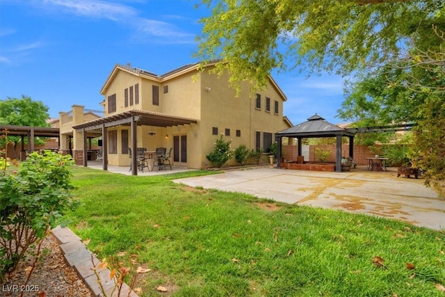 6335 Iginlas Goal Ave, Las Vegas, NV 89131 - back of property with a lawn, a gazebo, a patio, a pergola, and stucco siding