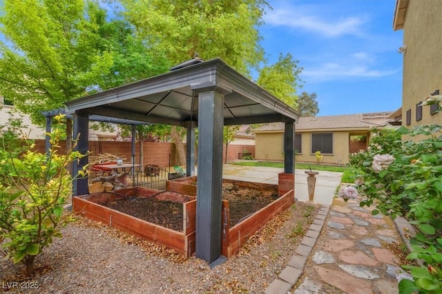 6335 Iginlas Goal Ave, Las Vegas, NV 89131 - view of patio featuring a gazebo, fence, and a garden