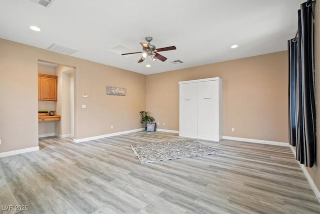 6335 Iginlas Goal Ave, Las Vegas, NV 89131 - unfurnished living room with baseboards, light wood-style flooring, ceiling fan, and visible vents
