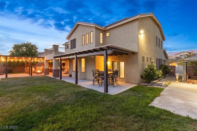 6335 Iginlas Goal Ave, Las Vegas, NV 89131 - rear view of house featuring a fenced backyard, a patio area, stucco siding, and a yard