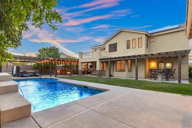 6335 Iginlas Goal Ave, Las Vegas, NV 89131 - back of house at dusk featuring a pergola, stucco siding, outdoor dining space, and a patio