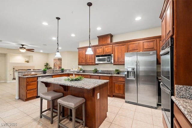 6335 Iginlas Goal Ave, Las Vegas, NV 89131 - kitchen with light tile patterned floors, brown cabinetry, stainless steel appliances, and a peninsula