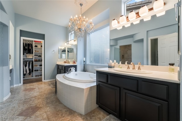 bathroom with a garden tub, a sink, a spacious closet, and a shower stall