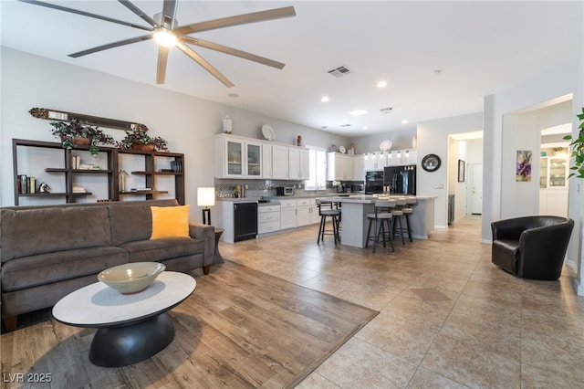 living area featuring visible vents, light tile patterned flooring, ceiling fan, and recessed lighting