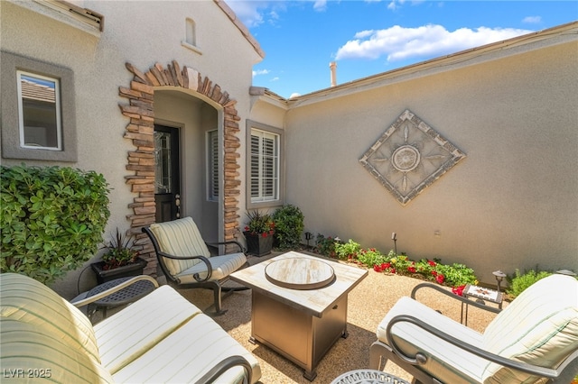 view of patio / terrace with an outdoor fire pit