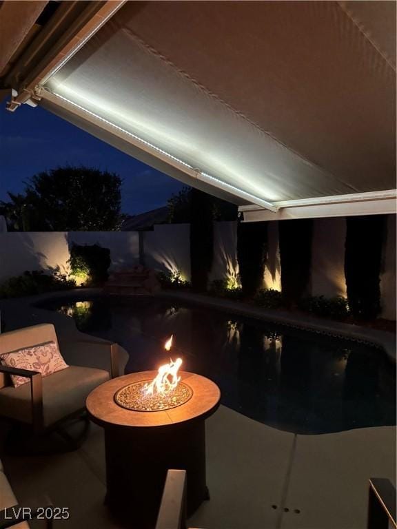 view of pool with a fire pit and a fenced in pool