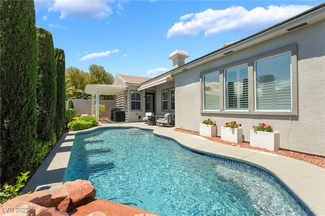 outdoor pool with a pergola, fence, and a patio