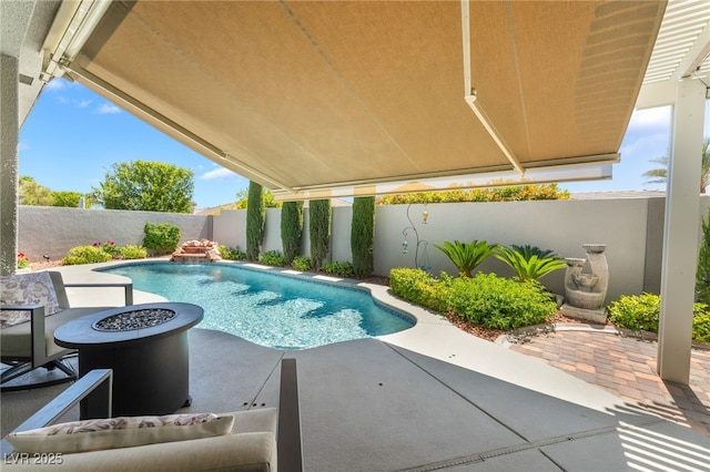 view of pool featuring an outdoor fire pit, a patio area, a fenced in pool, and a fenced backyard