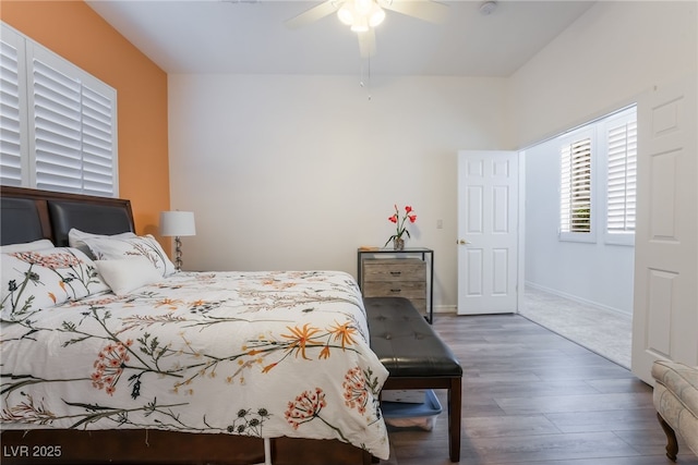 bedroom featuring baseboards, ceiling fan, and wood finished floors
