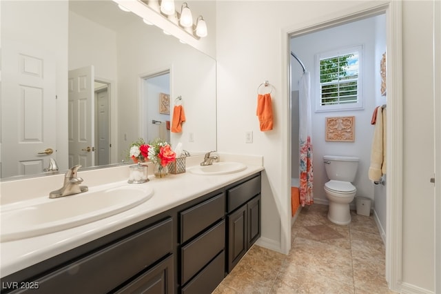 full bathroom featuring a sink, baseboards, toilet, and double vanity