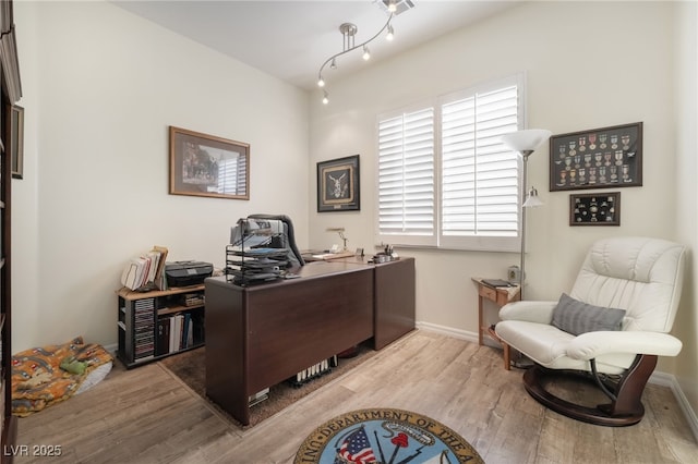 office with baseboards and wood finished floors