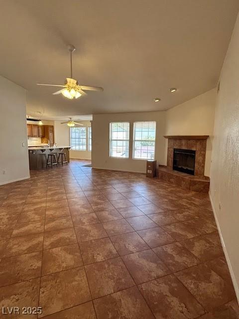 7650 Butterscotch Ct, Las Vegas, NV 89131 - unfurnished living room featuring a ceiling fan and a fireplace