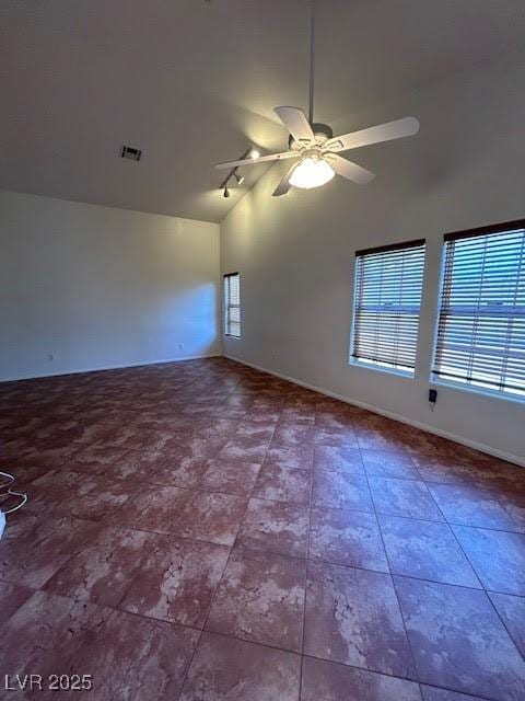 7650 Butterscotch Ct, Las Vegas, NV 89131 - empty room featuring a ceiling fan, rail lighting, and high vaulted ceiling