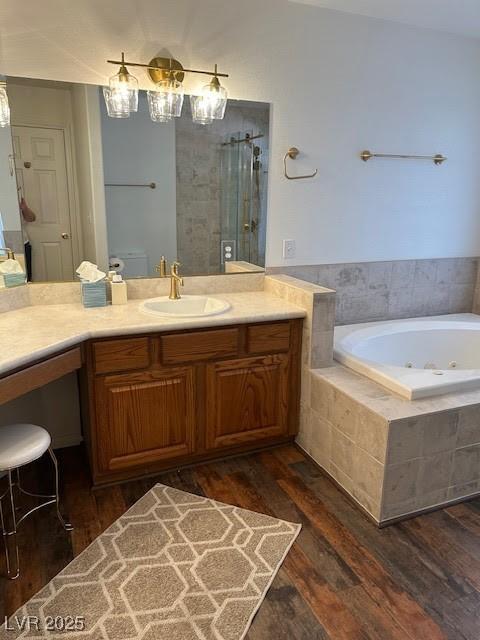 7650 Butterscotch Ct, Las Vegas, NV 89131 - bathroom featuring a jetted tub, wood finished floors, vanity, and a shower stall