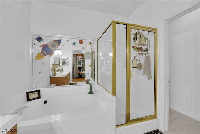 bathroom with vanity, tile patterned flooring, a bath, and a shower stall