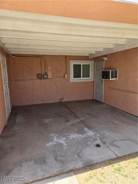 view of patio with a wall mounted air conditioner and a carport