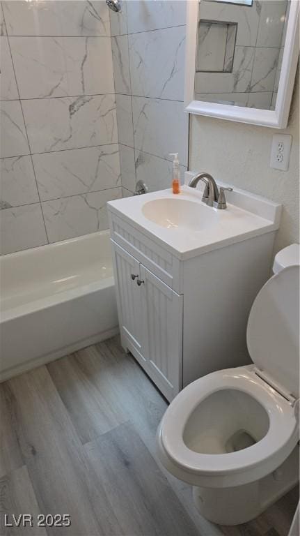 full bathroom featuring vanity, shower / bathtub combination, wood finished floors, and toilet