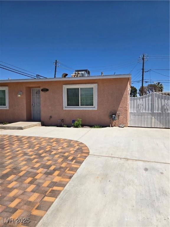 view of front of property with fence and stucco siding