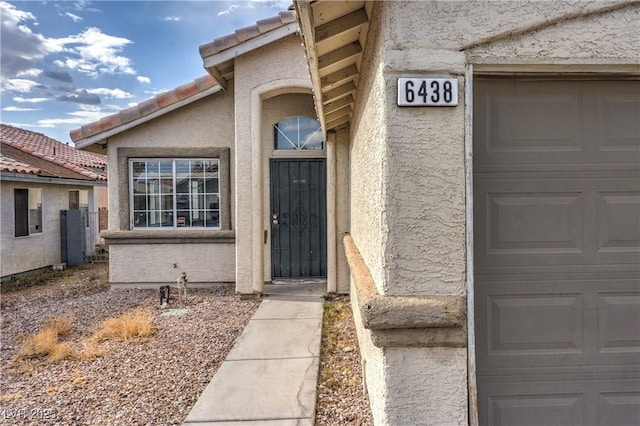6438 Rose Tree Ln, Las Vegas, NV 89156 - doorway to property featuring a tile roof and stucco siding