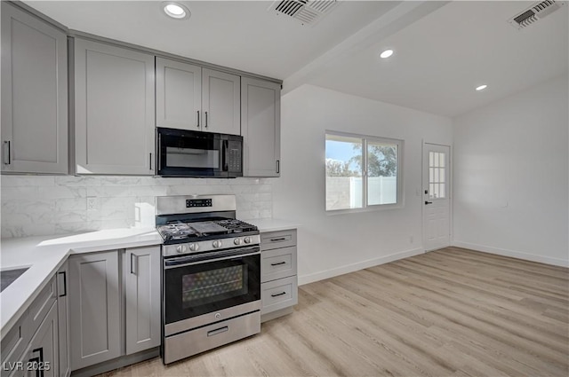 4419 Fairmont Cir, Las Vegas, NV 89147 - kitchen with visible vents, stainless steel gas range oven, black microwave, and gray cabinetry