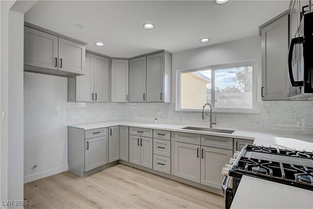 4419 Fairmont Cir, Las Vegas, NV 89147 - kitchen featuring a sink, backsplash, gray cabinetry, and black appliances