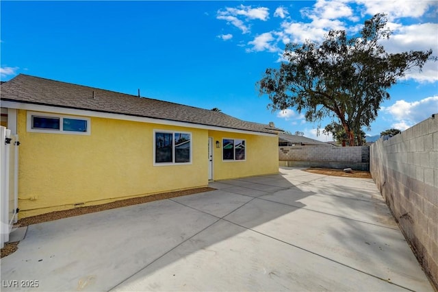 4419 Fairmont Cir, Las Vegas, NV 89147 - rear view of house with a fenced backyard, a patio area, and stucco siding
