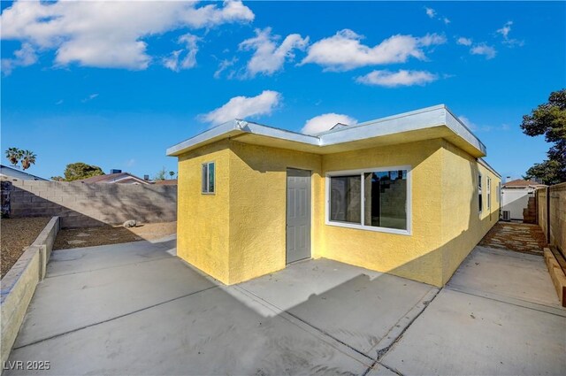 4419 Fairmont Cir, Las Vegas, NV 89147 - exterior space with a fenced backyard, a patio, and stucco siding