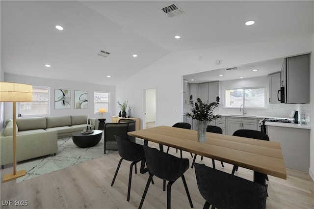 4419 Fairmont Cir, Las Vegas, NV 89147 - dining room with light wood-style floors, lofted ceiling, recessed lighting, and visible vents