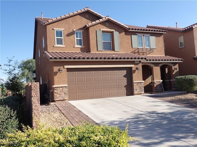 4361 Duck Harbor Ave, North Las Vegas, NV 89031 - view of front of property featuring a tiled roof, a garage, concrete driveway, stone siding, and stucco siding