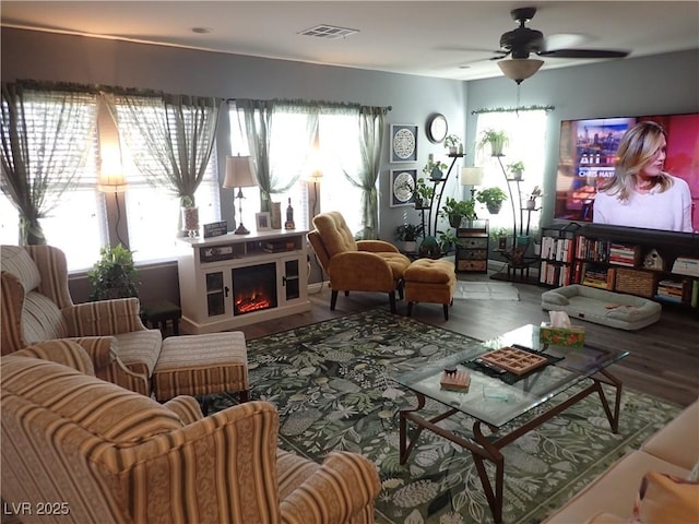 4361 Duck Harbor Ave, North Las Vegas, NV 89031 - living area with a ceiling fan, visible vents, wood finished floors, and a lit fireplace