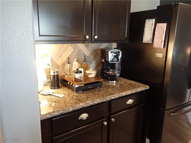 4361 Duck Harbor Ave, North Las Vegas, NV 89031 - interior space featuring freestanding refrigerator, bar, and tasteful backsplash