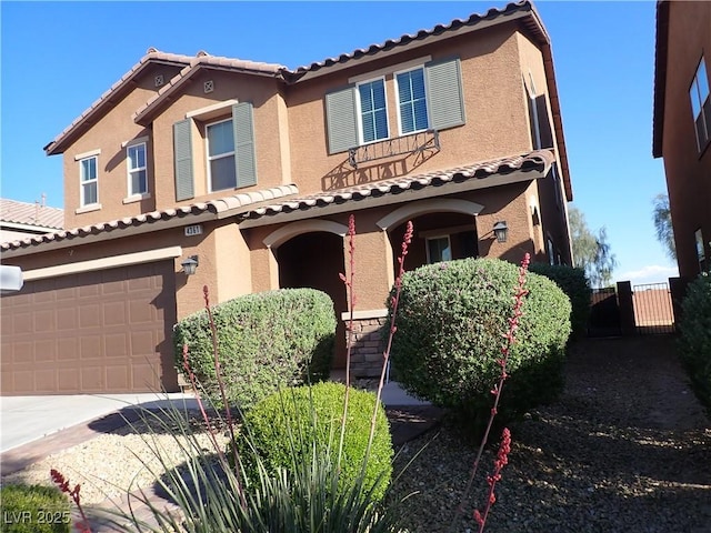 4361 Duck Harbor Ave, North Las Vegas, NV 89031 - mediterranean / spanish home with a garage, fence, a tile roof, and concrete driveway
