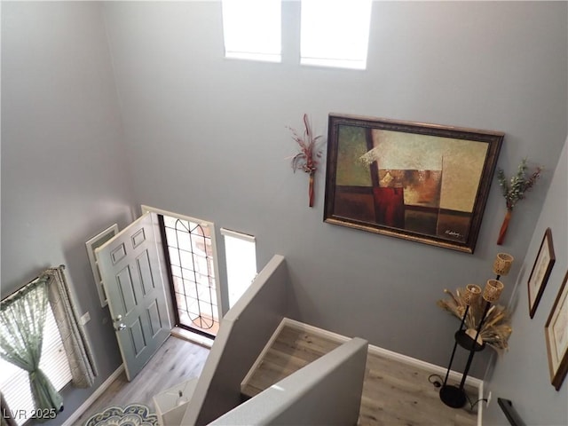 4361 Duck Harbor Ave, North Las Vegas, NV 89031 - staircase with baseboards, a high ceiling, and wood finished floors