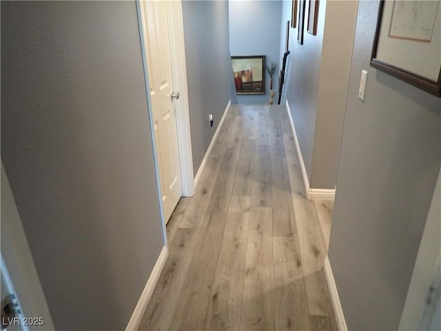 4361 Duck Harbor Ave, North Las Vegas, NV 89031 - hallway with baseboards and light wood-style flooring