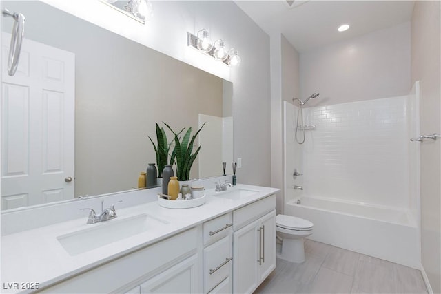 bathroom featuring a sink, shower / bathtub combination, toilet, and double vanity