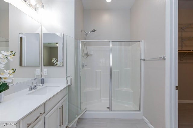 10251 Tiger Milkweed St, Las Vegas, NV 89141 - full bath featuring a shower stall, vanity, a spacious closet, and baseboards