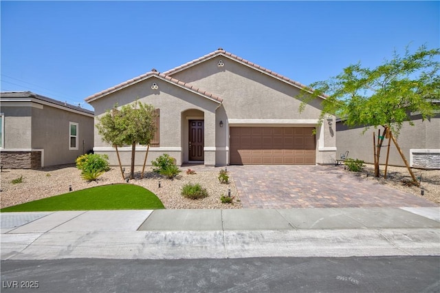 ranch-style house with a tiled roof, an attached garage, driveway, and stucco siding