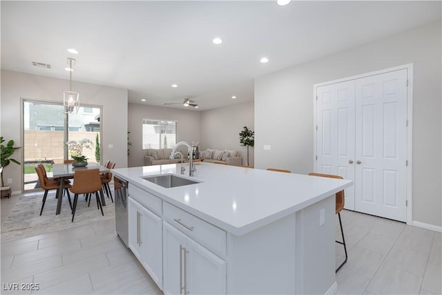 kitchen featuring visible vents, dishwasher, a sink, light countertops, and recessed lighting