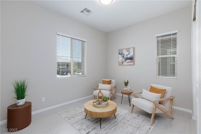 living area with visible vents and baseboards