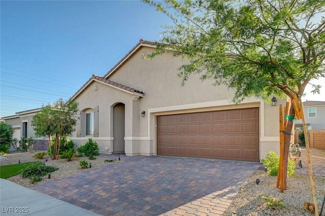 10251 Tiger Milkweed St, Las Vegas, NV 89141 - mediterranean / spanish house with stucco siding, decorative driveway, a garage, and a tile roof