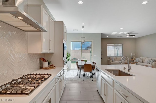 10251 Tiger Milkweed St, Las Vegas, NV 89141 - kitchen featuring wall chimney range hood, appliances with stainless steel finishes, light countertops, tasteful backsplash, and recessed lighting