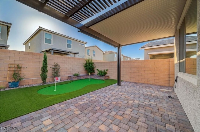 10251 Tiger Milkweed St, Las Vegas, NV 89141 - fenced backyard with a putting area and a patio
